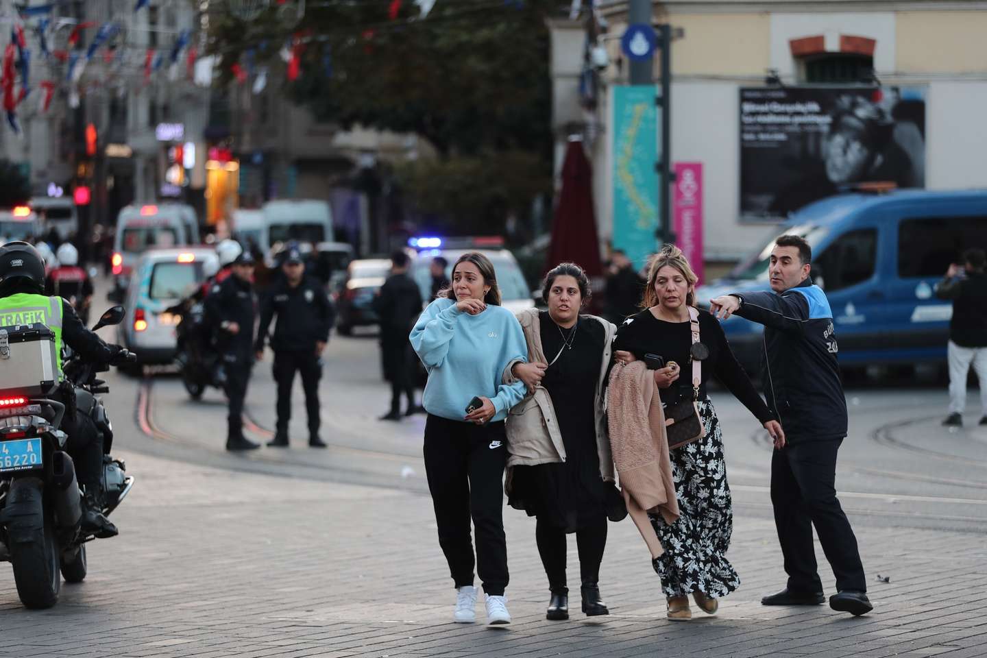 epa10303675 People run away as Turkish policemen try to secure the area after an explosion at Istiklal Street, in Istanbul, Turkey 13 November 2022. According to governor Ali Yerlikaya, an explosion that occurred at roughly 4.20 p.m. local time has resulted in losses and injuries. Emergency personnel were dispatched to the incident.  EPA/ERDEM SAHIN
