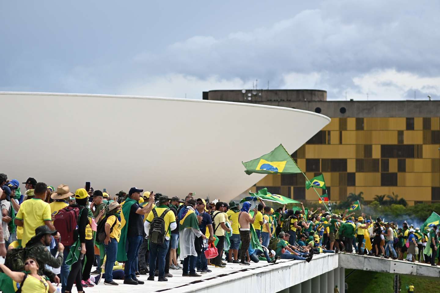 epa10396232 Bolsonaro supporters storm the National Congress in Brasilia, Brazil, 08 January 2023. Hundreds of supporters of former Brazilian President Jair Bolsonaro invaded the headquarters of the National Congress, and also Supreme Court and the Planalto Palace, seat of the Presidency of the Republic, in a demonstration calling for a military intervention to overthrow President Luiz Inacio Lula da Silva. The crowd broke through the cordons of security forces and forced their way to the roof of the buildings of the Chamber of Deputies and the Senate, and some entered inside the legislative headquarters.  EPA/ANDRE BORGES