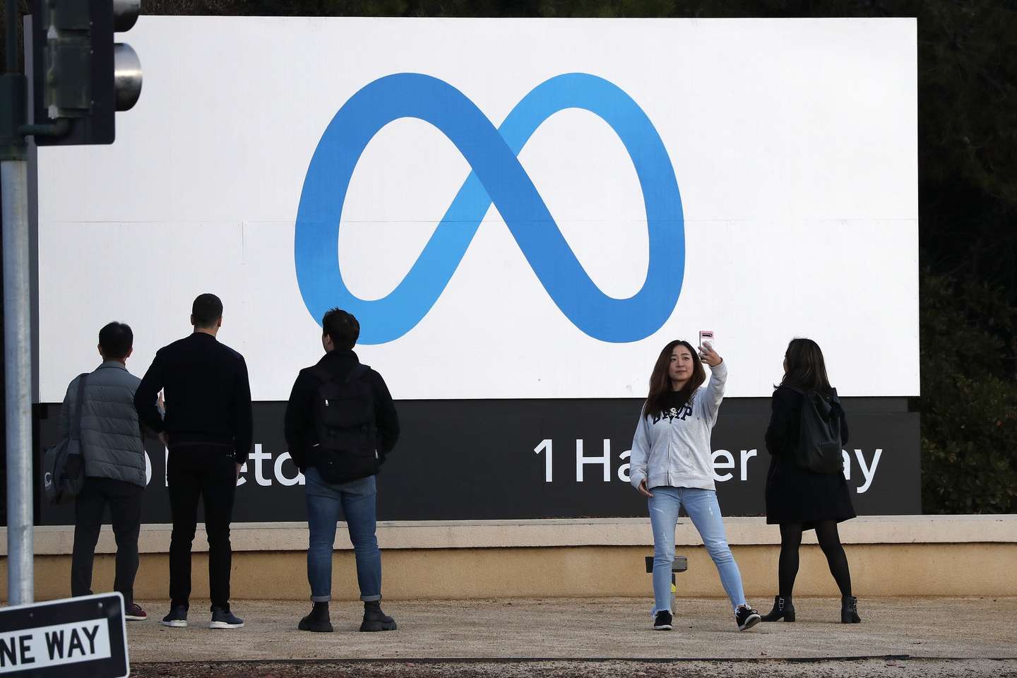 epa10296729 A person takes a selfie in front of the Meta billboard at the headquarters of Meta Platforms Inc., formerly named Facebook, Inc., in Menlo Park, California, USA, 09 November 2022. Chief Executive Mark Zuckerberg told company executives that Meta will begin laying off employees.  EPA/JOHN G. MABANGLO