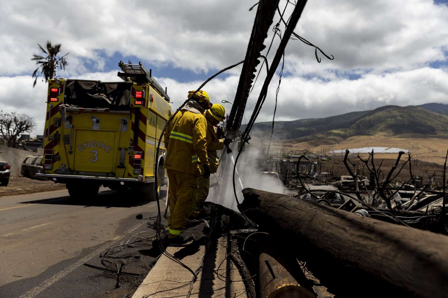 epa10796010 Firefighters put out a pocket of fire still burning in a neighborhood destroyed by a wild fire in Lahaina, Hawaii, USA, 11 August 2023. At least 67 people were killed in the wildfires burning in Maui, which is considered the largest natural disaster in Hawaii's state history.  EPA/ETIENNE LAURENT