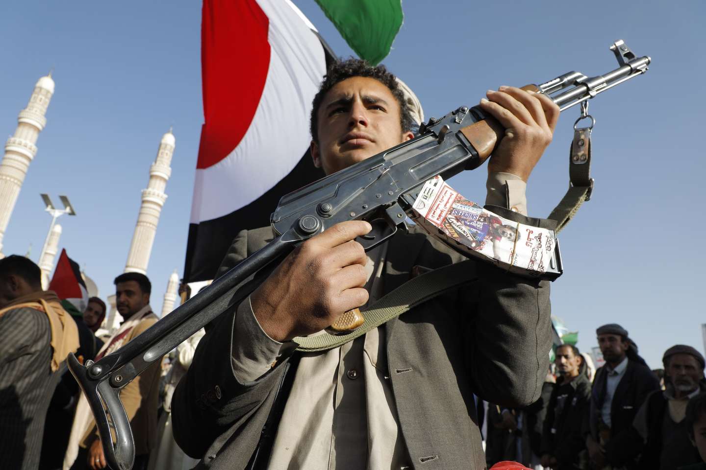 epaselect epa11041163 A man holds a gun during a protest against the recently announced operation to safeguard trade and to protect ships in the Red Sea, in Sana'a, Yemen, 22 December 2023. Thousands of people gathered at a square in the Houthis-controlled Sana'a to protest against the coalition created recently by the United States and denounce the Israeli strikes on the Gaza Strip. On 18 December, the US Department of Defense announced a multinational operation to safeguard trade and to protect ships in the Red Sea amid the recent escalation in Houthi attacks originating from Yemen, according to a press release from the US Department of Defense. Thousands of Israelis and Palestinians have died since the militant group Hamas launched an unprecedented attack on Israel from the Gaza Strip on 07 October, and the Israeli strikes on the Palestinian enclave which followed it.  EPA/OSAMAH YAHYA