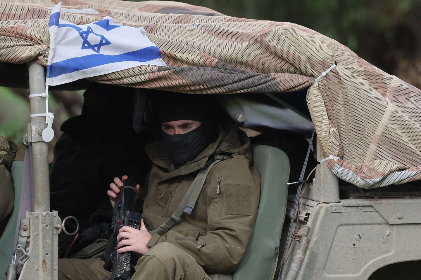 epaselect epa11039631 Israeli soldiers sit in a vehicle as they patrol near the Gaza Strip border, in southern Israel, 21 December 2023. More than 19,600 Palestinians and at least 1,200 Israelis have been killed, according to the Palestinian Health Ministry and the Israel Defense Forces (IDF), since Hamas militants launched an attack against Israel from the Gaza Strip on 07 October, and the Israeli operations in Gaza and the West Bank which followed it.  EPA/ABIR SULTAN