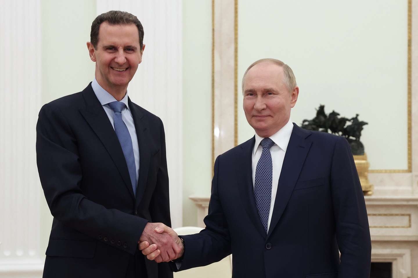 epa11495280 Russian President Vladimir Putin (R) and Syrian President Bashar al-Assad shake hands during their meeting at the Kremlin in Moscow, Russia, 24 July 2024 (issued 25 July 2024).  EPA/VALERY SHARIFULIN  / SPUTNIK / KREMLIN POOL