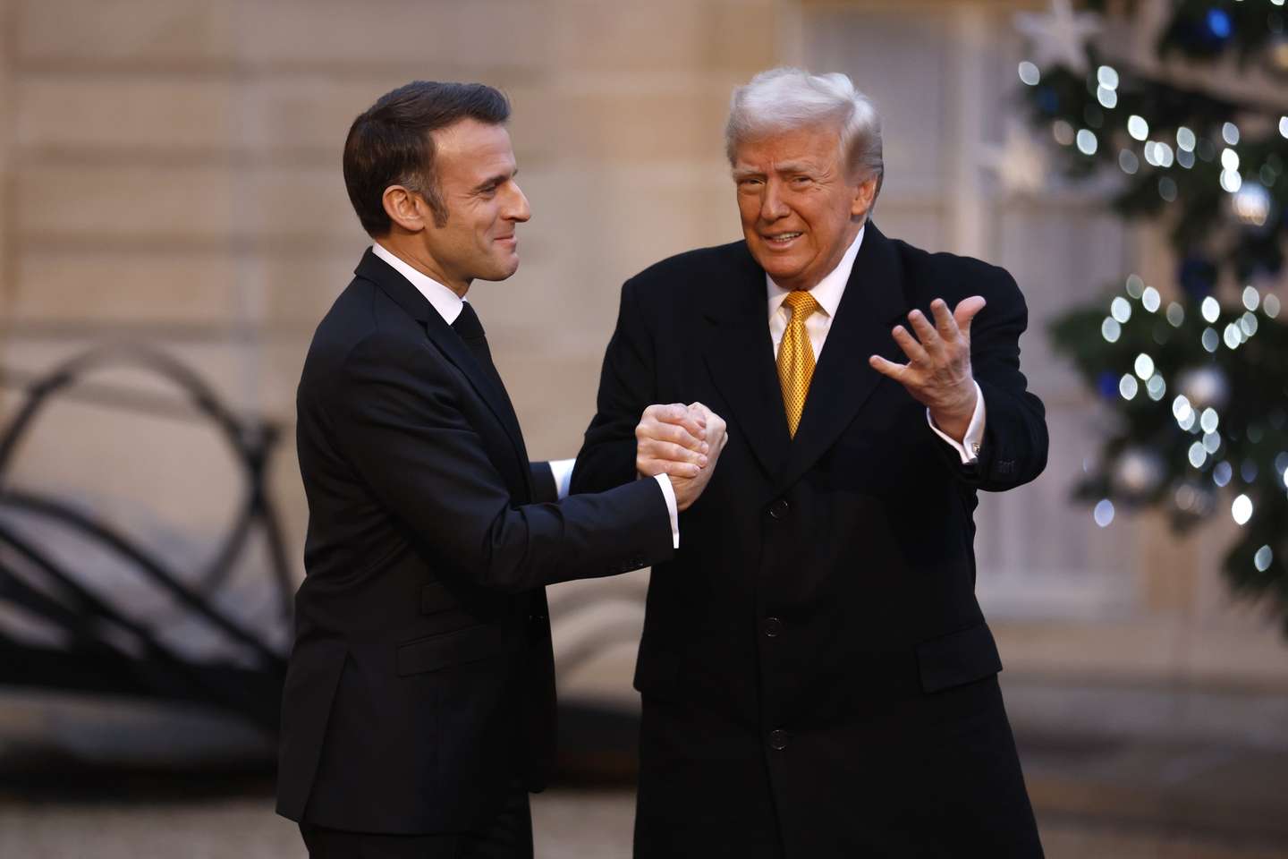 epa11762361 French President Emmanuel Macron (L) welcomes US president-elect Donald J. Trump at Elysee Palace prior the reopening ceremony of the Notre Dame de Paris Cathedral, in Paris, France, 07 December 2024. The Notre-Dame de Paris Cathedral reopens on 07 December after nearly six years of renovation work following its destruction by a fire on 15 April 2019.  EPA/MOHAMMED BADRA