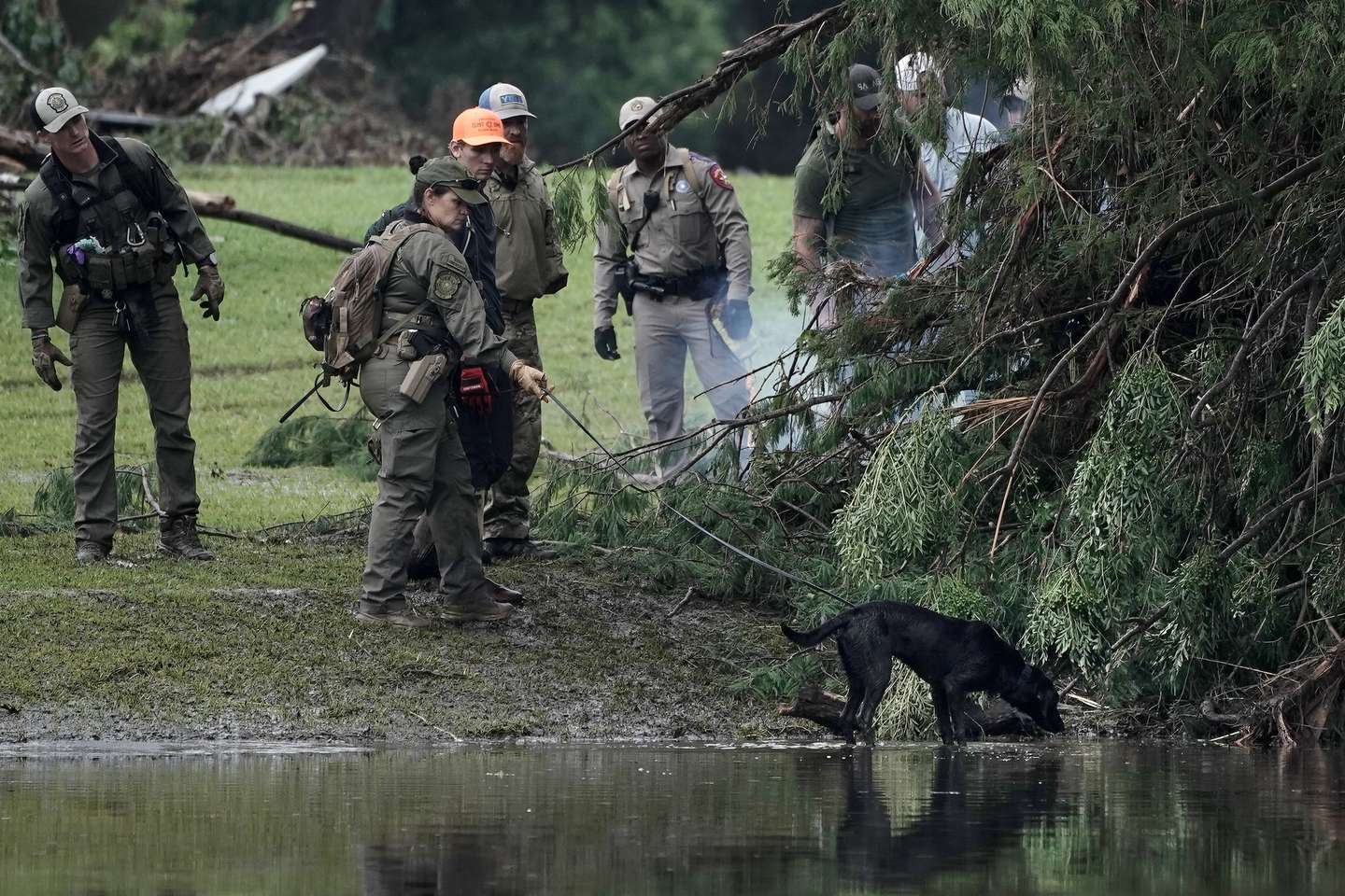 epa12220903 Emergency personnel search through vegetation and debris in Hunt, Texas, USA, 06 July 2025. At least 59 people have been killed after floodwaters swept through a summer camp and nearby homes on early 04 July.  EPA/DUSTIN SAFRANEK