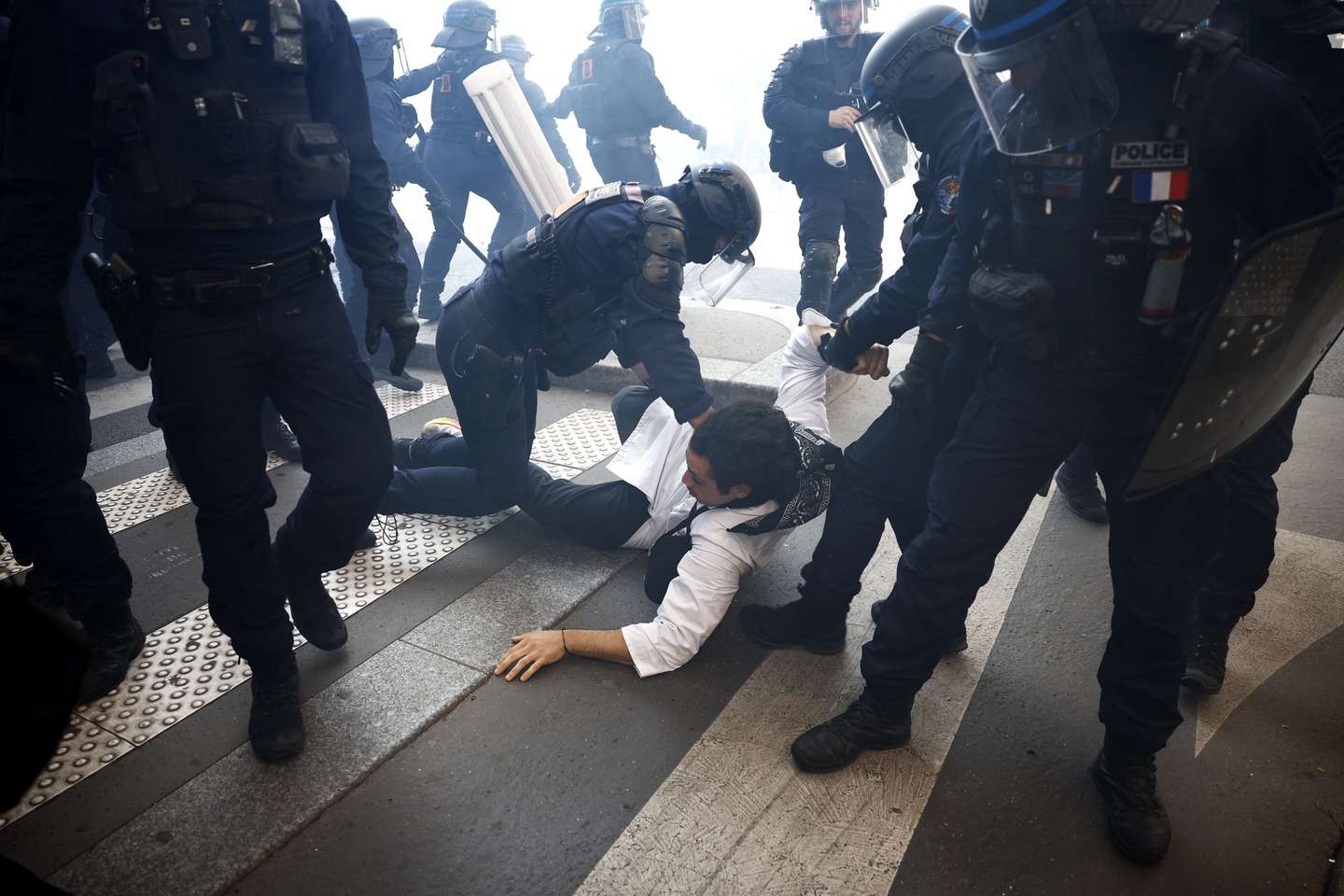 epa12387640 A protester arrested by riot police during a demonstration against austerity measures in the upcoming budget in Paris, France, 18 September 2025. French unions have called for a nationwide strike and mass protests against planned cuts in the government’s draft budget for 2026.  EPA/YOAN VALAT