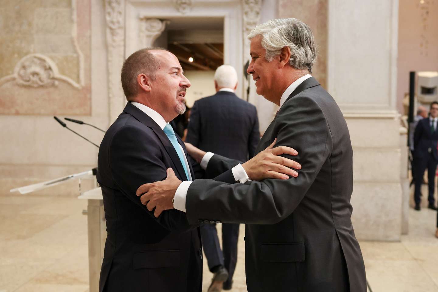 O novo governador do Banco de Portugal (BdP), Álvaro Santos Pereira (E), é cumprimentado pelo seu antecessor, Mário Centeno (D), na cerimónia de apresentação pública no Museu do Dinheiro, em Lisboa, 06 de outubro de 2025. JOÃO RELVAS/LUSA