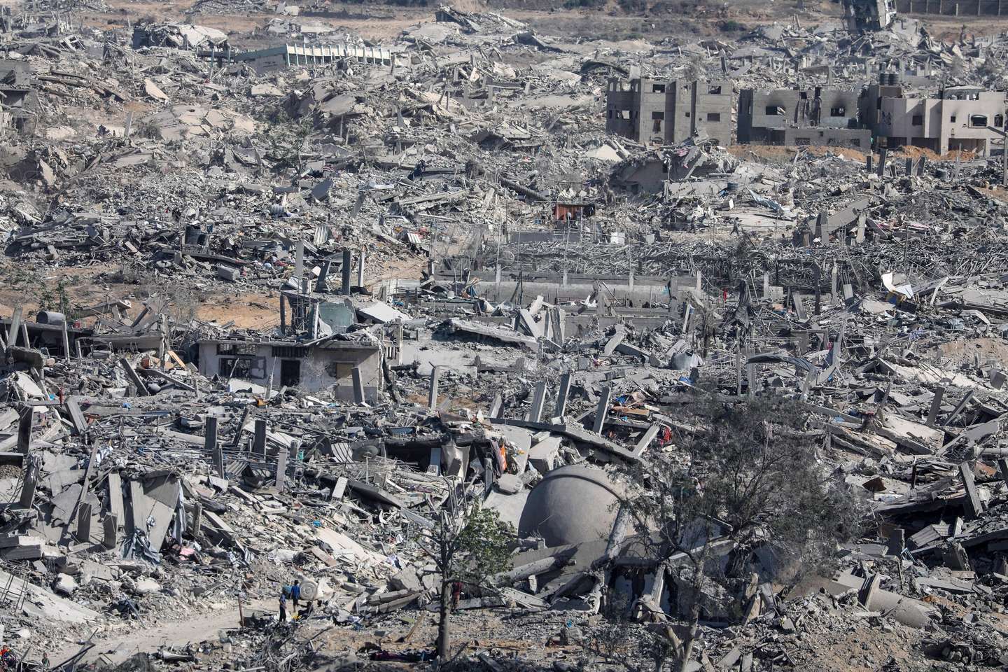 epa12447086 Internally displaced Palestinians walk along a street among the rubble of destroyed buildings amid a ceasefire between Israel and Hamas, in Gaza City, 11 October 2025. US President Donald Trump announced that Israel and Hamas have agreed to the first phase of a Gaza peace plan. The deal involves the release of Israeli hostages and Palestinian prisoners, the withdrawal of Israeli forces, and the delivery of humanitarian aid to Gaza.  EPA/MOHAMMED SABER