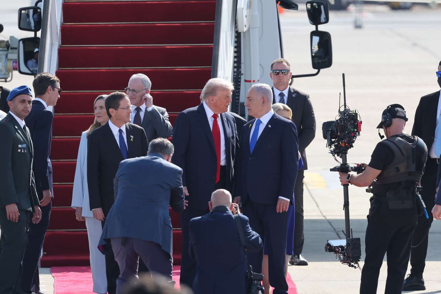 epa12449936 Israeli Prime Minister Benjamin Netanyahu (R), accompanied by Israeli President Isaac Herzog (L), welcomes US President Donald Trump (C) at Ben Gurion Airport in Tel Aviv, Israel, 13 October 2025. According to a parliament spokesperson for the Israeli Knesset, President Trump will deliver a speech at the Knesset on 13 October 2025 in light of a first phase ceasefire and hostages release deal between Israel and Hamas. US President Trump will then travel to Sharm el Sheikh, Egypt for a Peace Summit co-chaired with Egyptian President Abdel Fattah al Sisi and participation by around 20 world leaders with a goal to end the war in the Gaza Strip and enhance efforts to bring peace and stability to the Middle East.  EPA/ABIR SULTAN