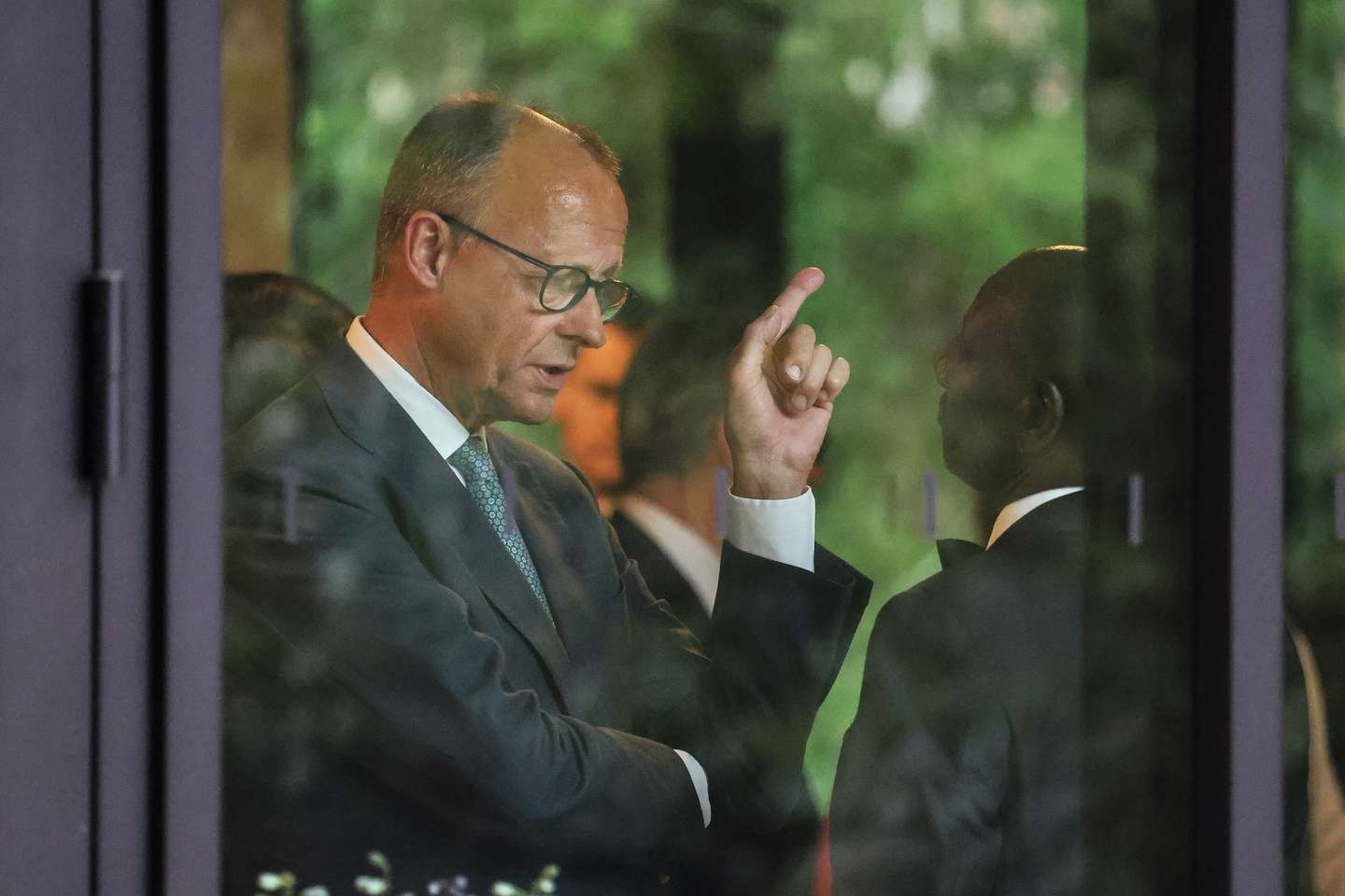 epa13042217 Germany's Chancellor Friedrich Merz (L) speaks with Kenya's President William Ruto before a group photo at the G7 summit in Evian-les-Bains, central-eastern France, 16 June 2026. The 52nd G7 Summit takes place in Evian-les-Bains from 15 to 17 June 2026.  EPA/LUDOVIC MARIN / POOL  MAXPPP OUT