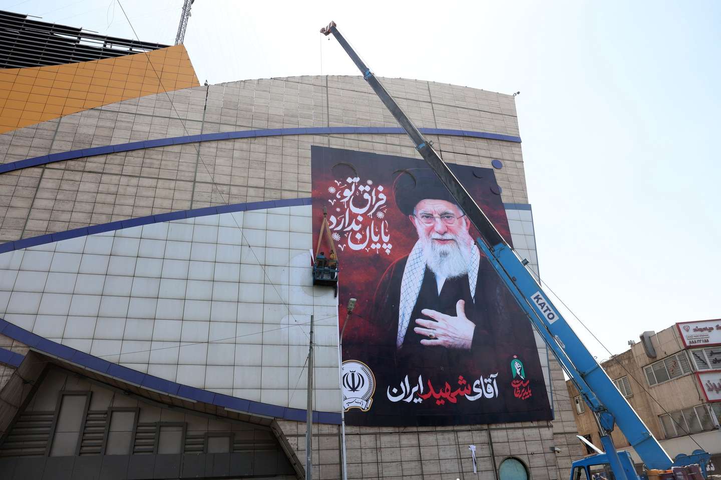 epa13082614 Iranian workers install a billboard of late Iranian Supreme Leader Ayatollah Ali Khamenei ahead of his funeral ceremonies in Tehran, Iran, 03 July 2026. Iran is set to hold a multi-day state funeral from 04 to 09 July for Khamenei, who was killed in a joint US and Israeli airstrike on 28 February.  EPA/ABEDIN TAHERKENAREH RESTRICTIONS: NO Access Israel Media/Persian Language TV Stations Outside Iran/Strictly No Access BBC Persian/VOA Persian/Manoto TV/Iran International TV. (As mandated by Iran's Directorate General for Foreign Media) --
