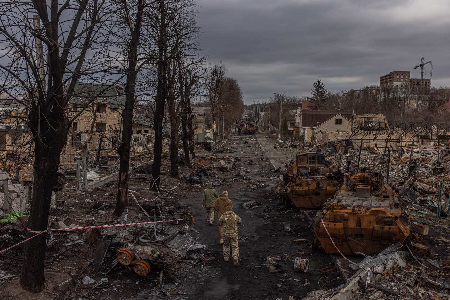 epa09874821 Members of the Ukrainian military walk past destroyed Russian military machinery on the street, in Bucha, the town which was retaken by the Ukrainian army, northwest of Kyiv, Ukraine, 06 April 2022. Hundreds of tortured and killed civilians have been found in Bucha and other parts of the Kyiv region after the Russian army retreated from those areas. Russian troops entered Ukraine on 24 February resulting in fighting and destruction in the country, and triggering a series of severe economic sanctions on Russia by Western countries.  EPA/ROMAN PILIPEY