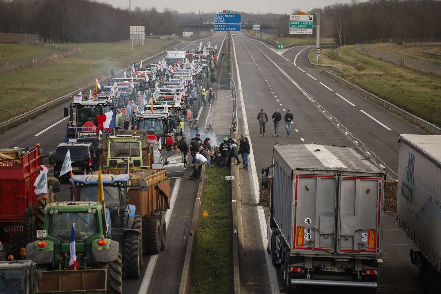 epa11114190 Dozens of tractors block part of the A4 motorway at Jossigny, east of Paris, France, 30 January 2024. French farmers continue their protests with road blockades and demonstrations in front of state buildings awaiting a response from the government to their request for 'immediate' aid of several hundred million euros. On 23 January, the EU Agriculture and Fisheries Council highlighted the importance of providing the conditions necessary to enable EU farmers to ensure food security sustainably and profitably, as well as ensuring a fair income for farmers.  EPA/YOAN VALAT