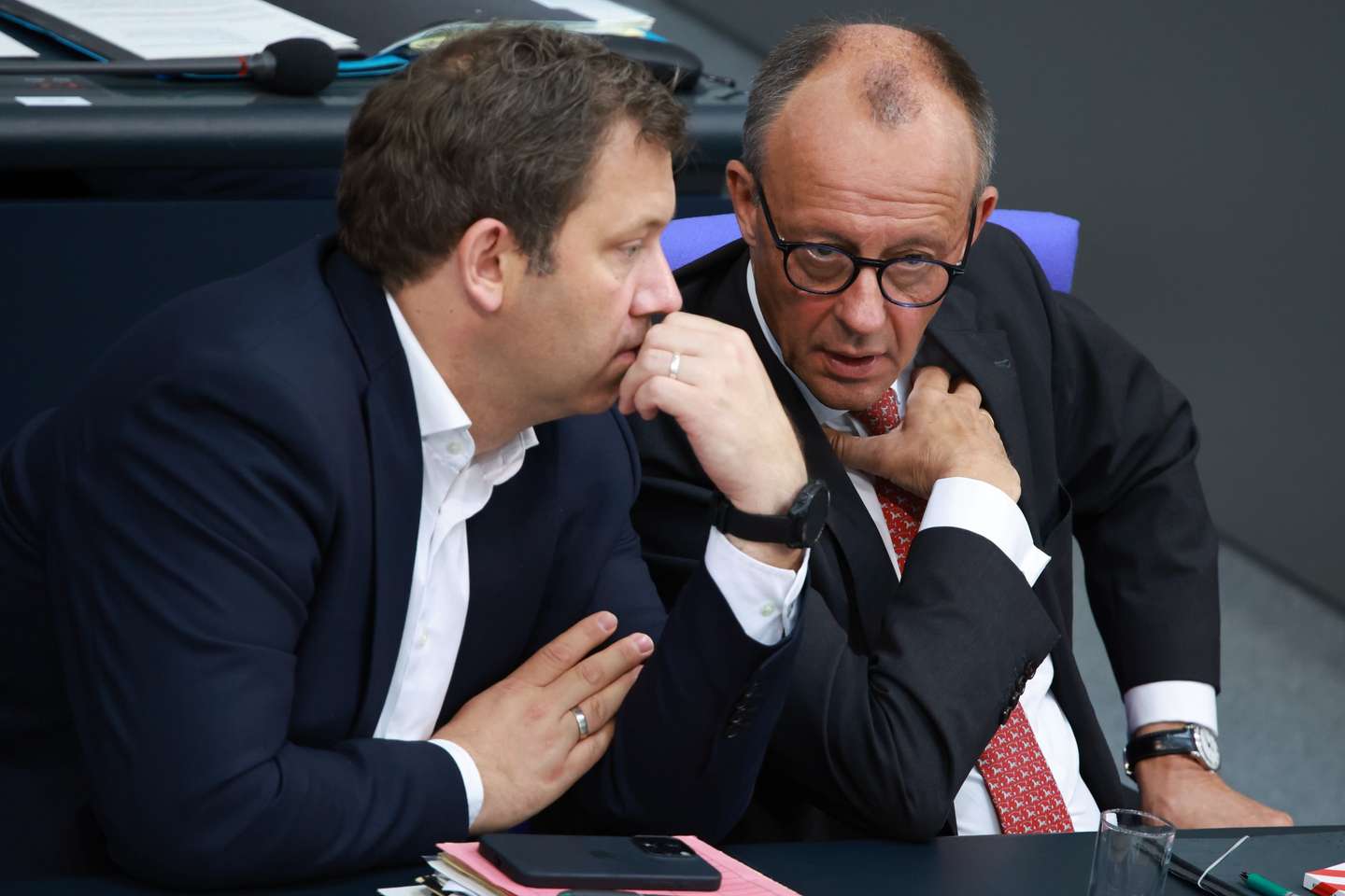 epa12384126 German Chancellor Friedrich Merz (R) and German Finance Minister Lars Klingbeil talk during a session of the German Parlaiment 'Bundestag' in Berlin, Germany, 17 September 2025. Members of the German Parliament discussed among other topics, the budget of the German Chancellory and the chancellor.  EPA/CLEMENS BILAN