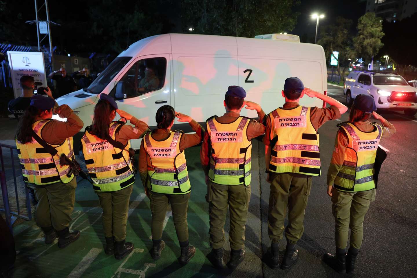 epa12456751 Israeli soldiers salute as a convoy carrying the bodies of two Israeli hostages that were handed over by Hamas arrives at the National Center of Forensic Medicine in Tel Aviv, Israel, 15 October 2025. The two bodies of the hostages kidnapped by Hamas on 07 October 2023 returned as part of a ceasefire deal between Israel and Hamas. Around twenty bodies of Israeli hostages remain in Hamas captivity.  EPA/ABIR SULTAN