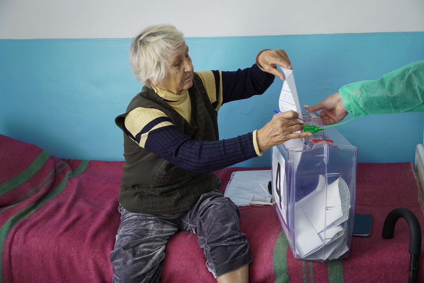 epa10207684 A woman casts her ballot during voting in a so-called referendum on the joining of Russian-controlled regions of Ukraine to Russia, in a hospital in Berdyansk, Zaporizhzhia region, Ukraine, 25 September 2022. From 23 to 27 September, residents of the self-proclaimed Luhansk and Donetsk People's Republics as well as the Russian-controlled areas of the Kherson and Zaporizhzhia regions of Ukraine are voting in ''referendums'' to join the Russian Federation that Ukraine call a farce. On 24 February 2022 Russian troops entered the Ukrainian territory in what the Russian president declared a 'Special Military Operation', starting an armed conflict that has provoked destruction and a humanitarian crisis.  EPA/STRINGER