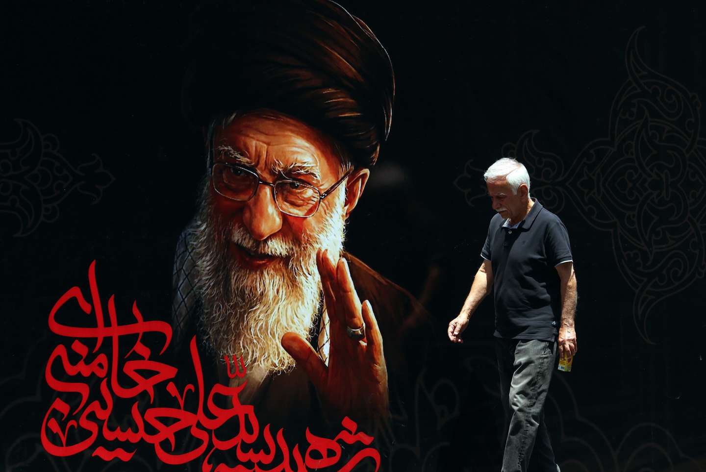 epaselect epa13082608 An Iranian man walks in front of a billboard of late Iranian Supreme Leader Ayatollah Ali Khamenei ahead of his funeral ceremonies in Tehran, Iran, 03 July 2026. Iran is set to hold a multi-day state funeral from 04 to 09 July for Khamenei, who was killed in a joint US and Israeli airstrike on 28 February.  EPA/ABEDIN TAHERKENAREH RESTRICTIONS: NO Access Israel Media/Persian Language TV Stations Outside Iran/Strictly No Access BBC Persian/VOA Persian/Manoto TV/Iran International TV. (As mandated by Iran's Directorate General for Foreign Media) --