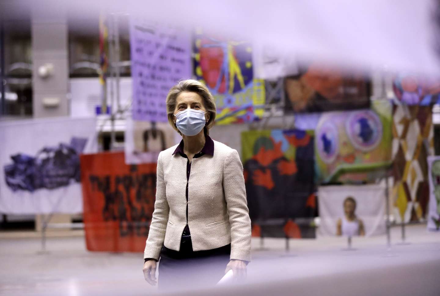 epa08956717 European Commission President Ursula von der Leyen looks at artworks of the Portguese presidency prior a press conference after a video summit of the European Council members, in Brussels, Belgium, 21 January 2021. EU member countries' heads of states and governments agreed on keeping the intra-EU borders open although restrictions on non-essential travel are an option in order to combat the spread of the pandemic Sars-CoV-2 coronavirus and its variants.  EPA/OLIVIER HOSLET / POOL