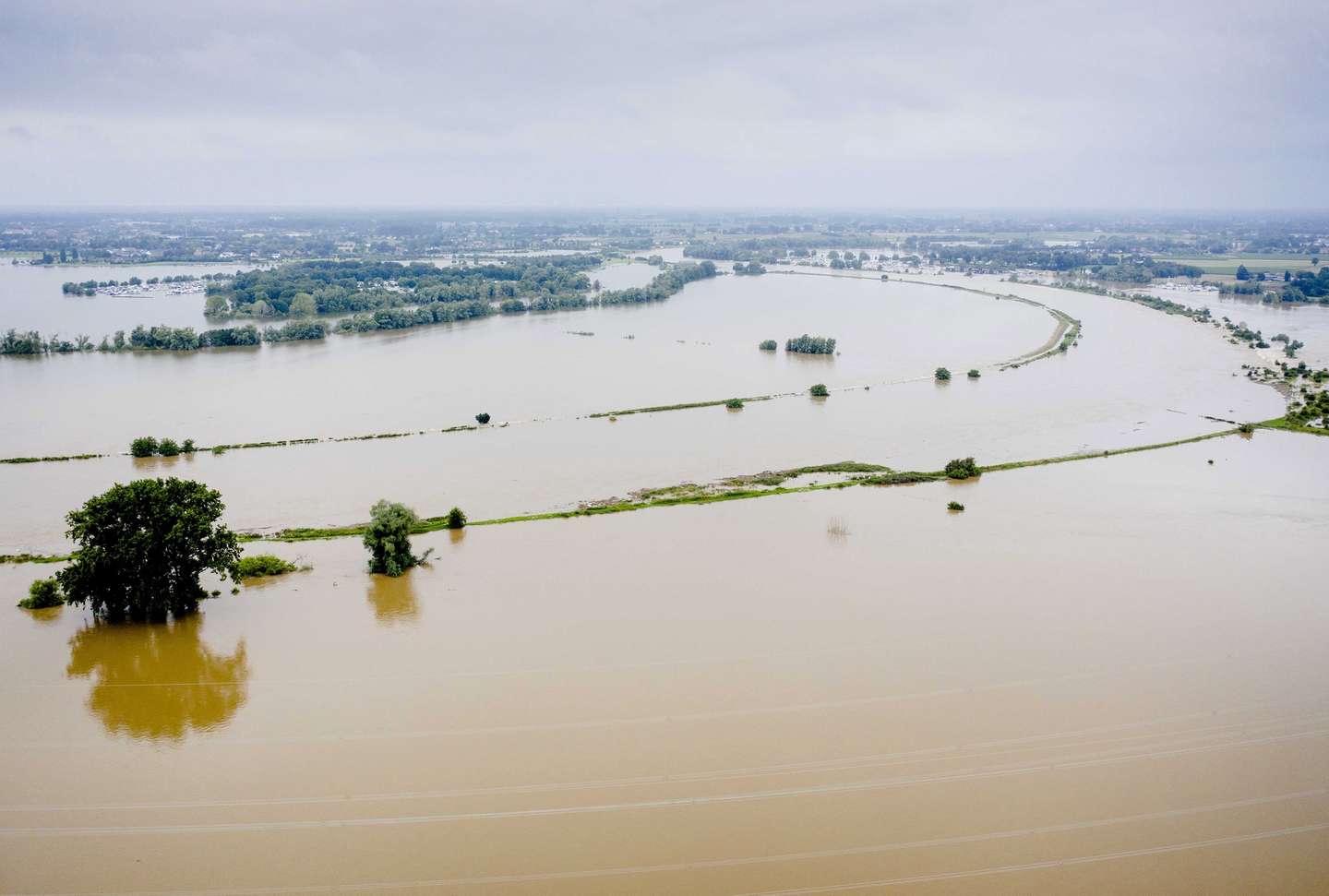 epa09348328 Image taken with a drone showing sustantial flooding near the Limburg hamlet of Aasterberg, Netherlands, 16 July 2021. Recent heavy rains have caused water levels in the river Meuse to rise, making the area difficult to access.  EPA/SEM VAN DER WAL