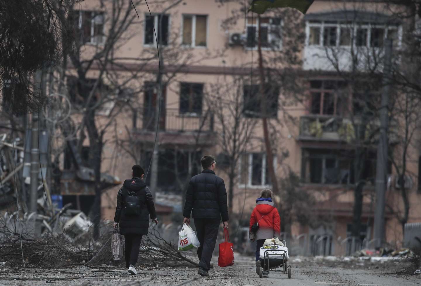 epa09886438 A picture taken during a visit to Mariupol organized by the Russian military shows local people walk on the Mira avenue in downtown of Mariupol, Ukraine, 12 April 2022. There is no water, electricity, gas or communications, and shops, pharmacies and hospitals are closed. Up to 70 percent of the housing stock of Mariupol was destroyed, said the newly appointed mayor of the city Konstantin Ivashchenko. Some 133,214 people, including two thousand people over the past day, left Mariupol through the gum corridor in the eastern direction, according to the head of the Russian National Defense Control Center. On 24 February Russian troops had entered Ukrainian territory in what the Russian president declared a 'special military operation', resulting in fighting and destruction in the country, a huge flow of refugees, and multiple sanctions against Russia.  EPA/SERGEI ILNITSKY