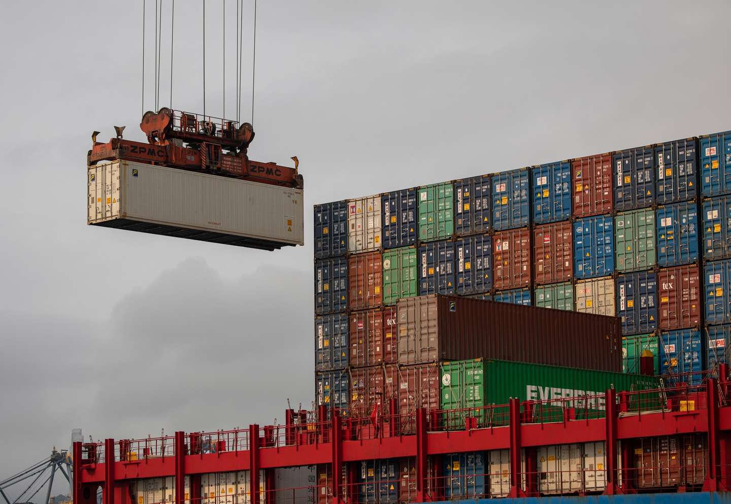 epa09104583 A ship is loaded with containers in the Kwai Tsing Terminals in Hong Kong, China, 29 March 2021. The fourth quarter 2020 total port cargo throughput decreased by 9.5 percent compared with the fourth quarter of 2019 to 61.3 million tonnes according to Hong Kong's Census and Statistics Department.  EPA/JEROME FAVRE