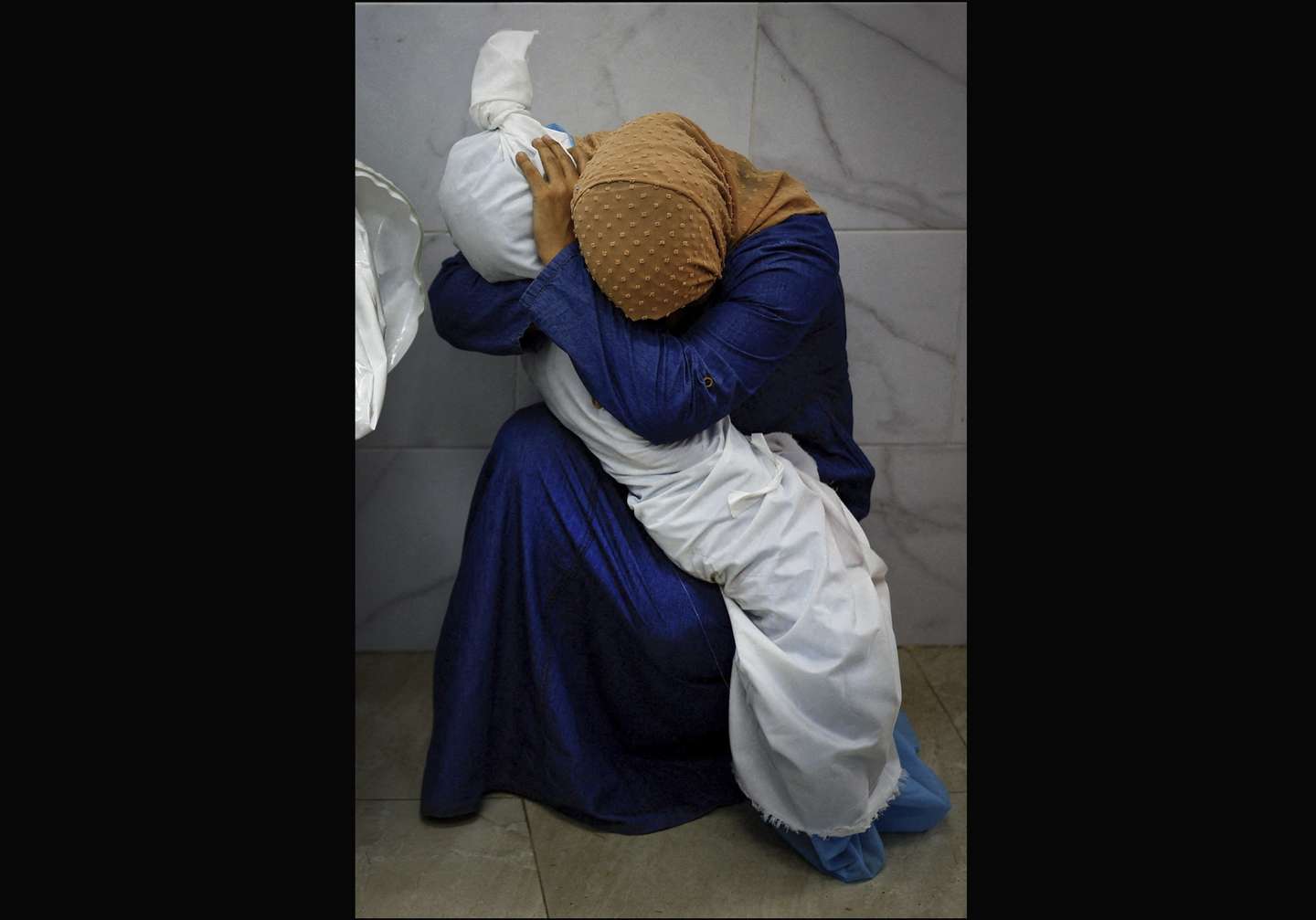 epa11286015 A handout photo made available by the World Press Photo Foundation shows the 2024 World Press Photo Award winner image by Mohammed Salem for Reuters depicting Inas Abu Maamar (36) cradling the body of her niece Saly (5) who was killed, along with four other family members, when an Israeli missile struck their home in Khan Younis, Gaza Strip, 17 October 2023 (reissued 18 April 2024). The 2024 World Press Photo Winners were announced by the World Press Photo Foundation on 18 April 2024.  EPA/MOHAMMED SALEM / HANDOUT MANDATORY CREDIT: Mohammed Salem/World Press Photo Foundation -- NO COVERS -- NO CROPPING, RESIZING, MANIPULATING -- NO SOCIAL MEDIA USAGE  HANDOUT EDITORIAL USE ONLY/NO SALES HANDOUT EDITORIAL USE ONLY/NO SALES