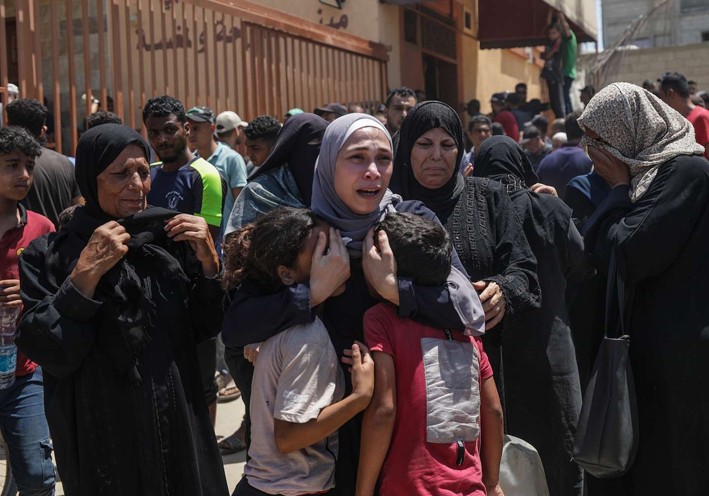 epaselect epa11476047 A Palestinian woman (C) reacts with her children as she mourns after her husband was killed following an Israeli air strike in the Al-Mawasi area of Khan Yunis, southern Gaza Strip, 13 July 2024. At least 71 Palestinians have been killed and 289 others injured after an Israeli military strike hit near tents of displaced people in the Al-Mawasi area of Khan Yunis, according to the Palestinian Ministry of Health. The Israeli military stated on 13 July, it targeted senior Hamas leaders in the area of Khan Yunis. More than 38,000 Palestinians and over 1,455 Israelis have been killed, according to the Palestinian Health Ministry and the IDF, since Hamas militants launched an attack against Israel from the Gaza Strip on 07 October 2023, and the Israeli operations in Gaza and the West Bank which followed it.  EPA/MOHAMMED SABER