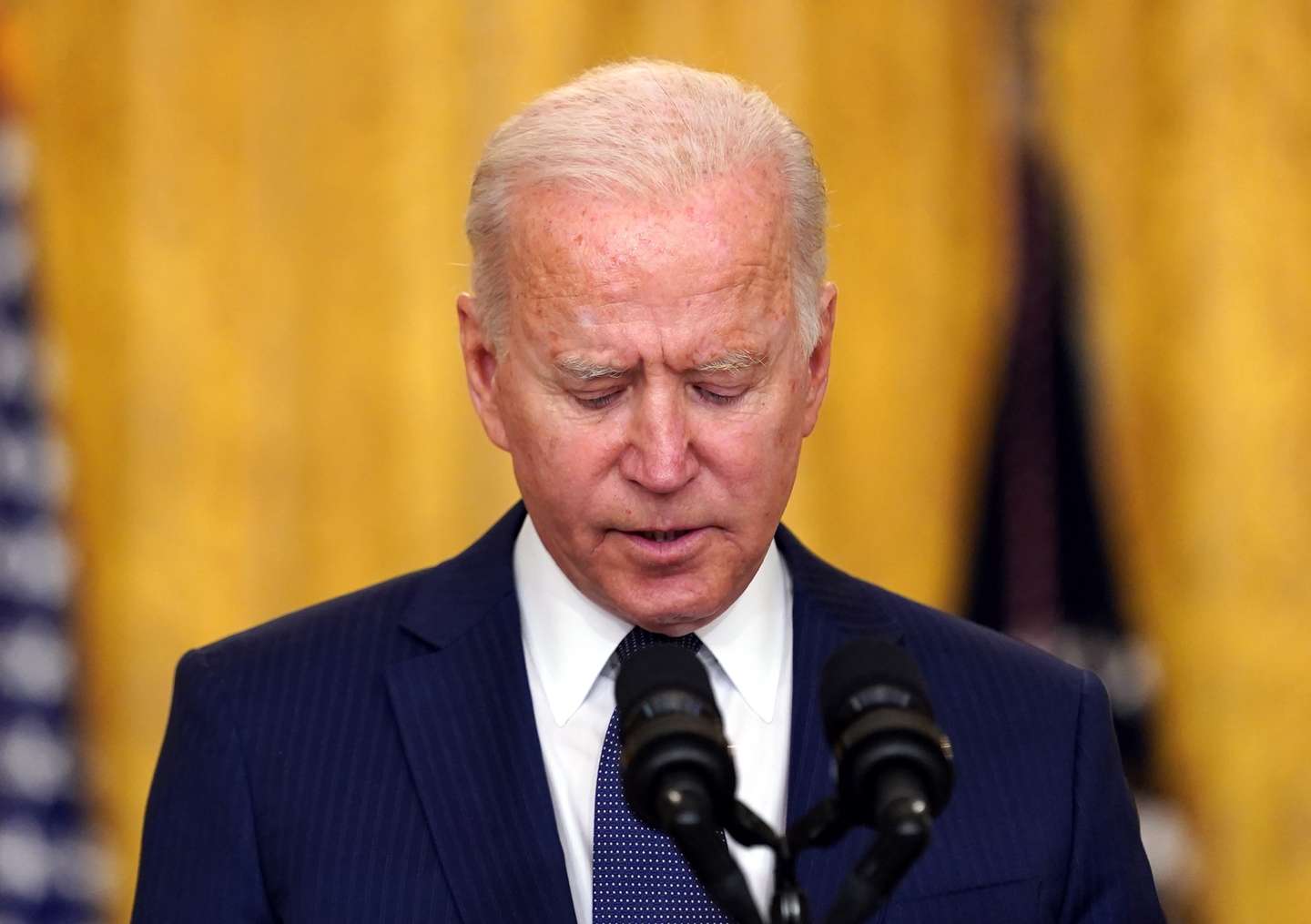 epa09431373 US President Joe Biden delivers remarks on the terror attack at Hamid Karzai International Airport in Kabul Afghanistan, and the US service members and Afghan victims killed and wounded, from the East Room of the White House in Washington, DC, USA, 26 August 2021.  EPA/Stefani Reynolds / POOL