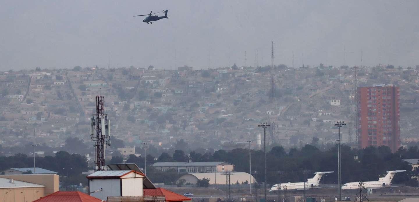 epa09416575 A US Black Hawk military helicopter fly over the Kabul Airport, after Taliban took control of Kabul, Afghanistan, 16 August 2021. Several people were reportedly killed at Kabul airport on 16 August as Afghans were attempting to hang on a moving US military plane leaving the airport. Taliban co-founder Abdul Ghani Baradar earlier in the day declared victory and an end to the decades-long war in Afghanistan, a day after the insurgents entered Kabul to take control of the country. Baradar, who heads the Taliban political office in Qatar, released a short video message after President Ashraf Ghani fled and conceded that the insurgents had won the 20-year war.  EPA/STRINGER