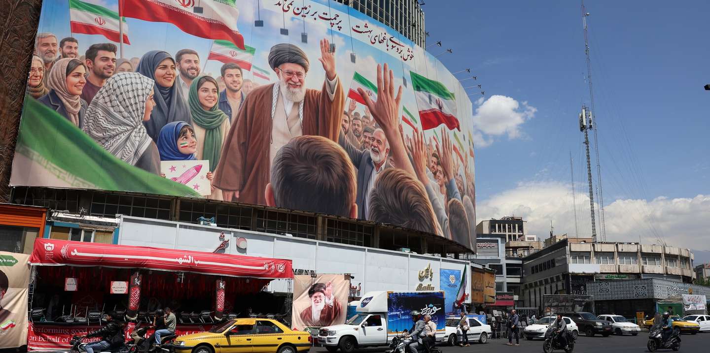 epa12918543 Iranians drive past a huge billboard carrying a picture of the late Iranian Supreme Leader Ayatollah Ali Khamenei in Tehran, Iran, 28 April 2026. US President Donald Trump announced that a ceasefire between the US and Iran has been extended.  EPA/ABEDIN TAHERKENAREH