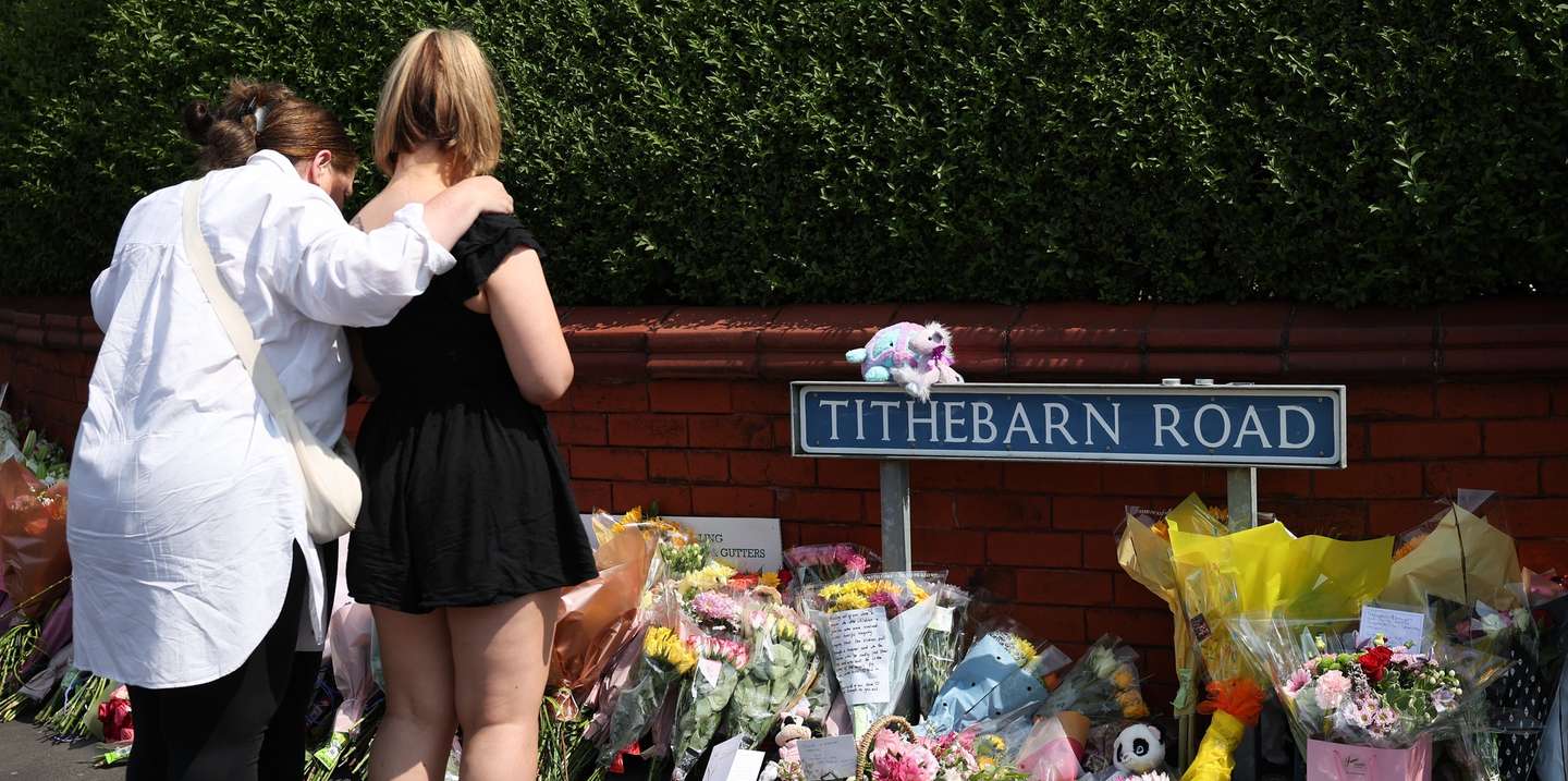 epa11508689 People look at tributes left at the scene of a stabbing attack at the junction with Hart Street in Southport, Britain, 30 July 2024. Merseyside Police confirmed on 30 July that a third child aged 9 has died as a result of a knife attack in Southport the previous day, and confirmed that the other two victims were ages six and seven respectively. Five other children and two adults remain in critical condition. Armed police detained a 17-year-old boy on suspicion of murder and attempted murder, while the motivation for the attack was not being treated as terrorist related.  EPA/ADAM VAUGHAN