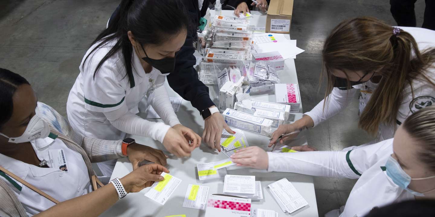 epa09114144 Medical professionals prepare COVID-19 vaccination record cards to issue to people after they are inoculated at a mass vaccination event hosted by Unity Health Care, at Walter E. Washington Convention Center in Washington, DC, USA, 03 April 2021. About one thousand people were inocculated with the Moderna COVID-19 vaccine at the event. Authorities are encouraging people to continue to use face masks after being vaccinated.  EPA/MICHAEL REYNOLDS