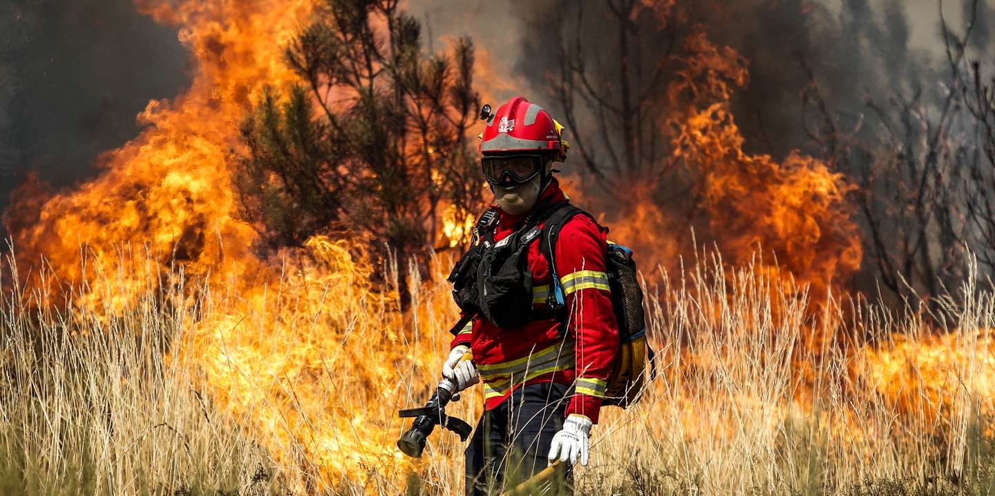 Um bombeiro combate as chamas durante o incêndio na encosta da aldeia de Moura da Serra, Arganil, 14 de agosto de 2025. De acordo com os dados disponíveis no ‘site’ da Autoridade Nacional de Emergência e Proteção Civil (ANEPC), quase 900 operacionais combatiam o fogo que deflagrou na quarta-feira na freguesia de Piódão, no concelho de Arganil, distrito de Coimbra, e se estendeu depois aos municípios de Oliveira do Hospital e Pampilhosa da Serra (Coimbra), e de Seia, já no distrito da Guarda. PAULO CUNHA/LUSA