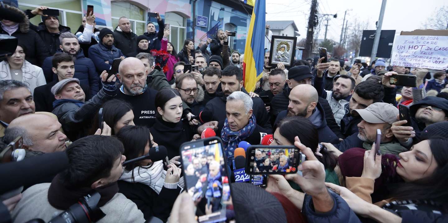 epaselect epa11764093 Calin Georgescu, Romania's independent candidate who won the first round of the presidential elections, talks to the media outside the Secondary School No. 1 polling station, where he was scheduled to cast his vote in the second round of the presidential elections in Mogosoaia, near Bucharest, Romania, 08 December 2024. The Romanian Constitutional Court (CCR) annulled the first round of presidential elections on 06 December. According to the CCR, the government will set a new election date, and the entire electoral process will be re-run, beginning with candidate registration and validation.  EPA/ROBERT GHEMENT