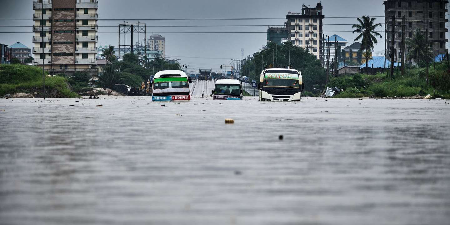 epa11300393 Vehicles are stuck in a flooded street in Jangwani, Dar Es Salaam, Tanzania, 25 April 2024. Tanzania Prime Minister Kassim Majaliwa said at least 155 people have died in Tanzania as torrential rains linked to El Nino weather phenomenon caused flooding and landslides, affecting about 200,000 people.  EPA/DIEGO MENJIBAR