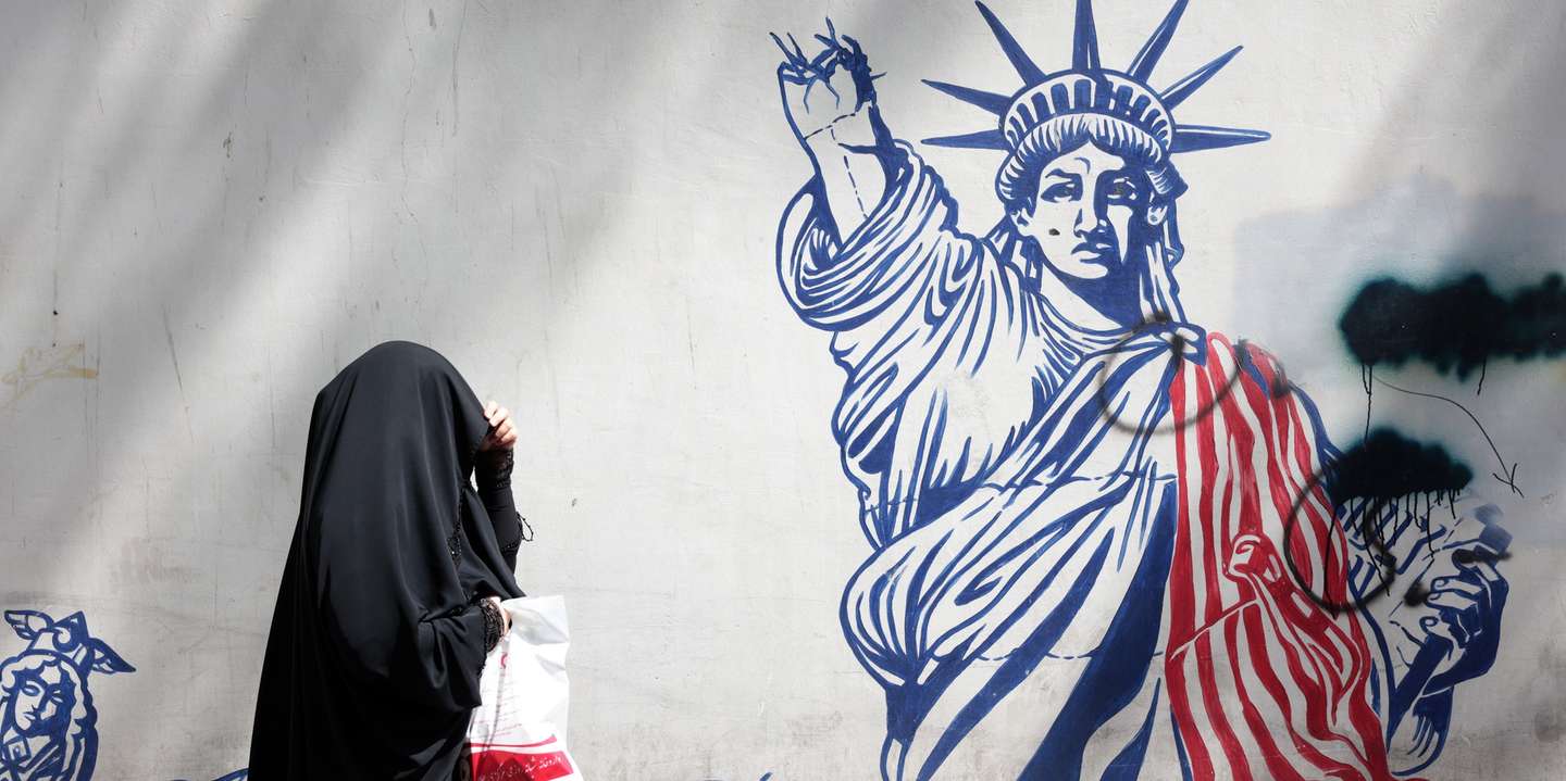 epaselect epa12090200 A woman walks next to an anti-US mural in front of the former US embassy in Tehran, Iran, 11 May 2025. Iran and the US hold their fourth round of nuclear talks in Muscat on the same day.  EPA/ABEDIN TAHERKENAREH