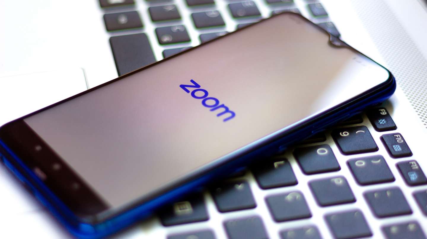 In this photo illustration a Zoom Video Communications logo
