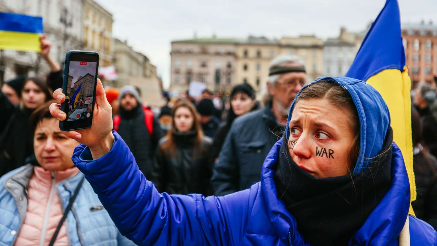A protester streams live video of demonstration using her