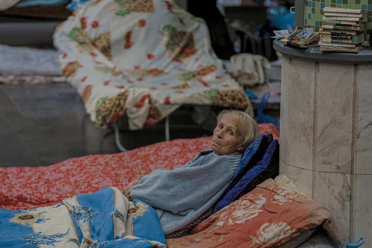 An elderly woman lies on the floor inside the Kharkiv metro