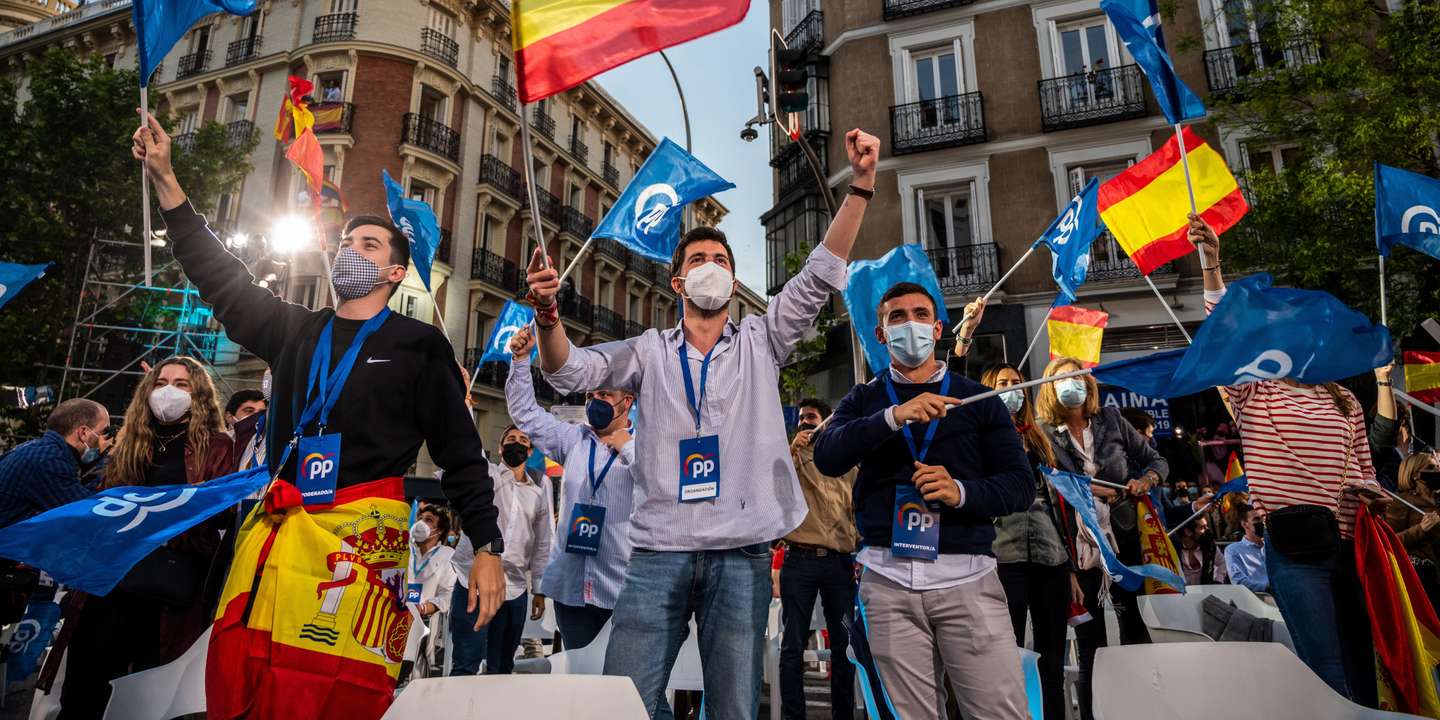 Supporters of Popular Party (PP) waving flags as they follow