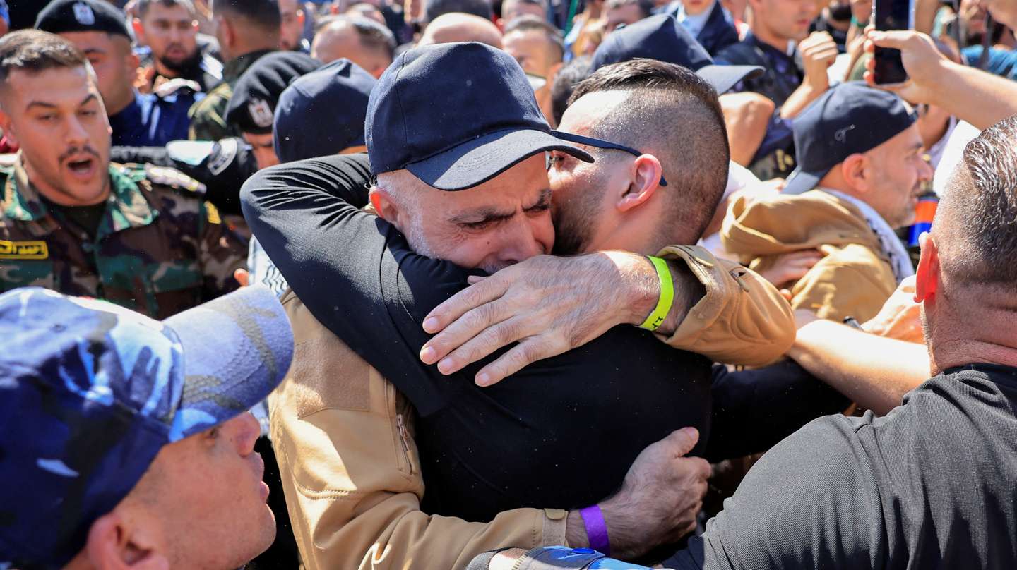 A freed Palestinian prisoner hugs his family member after being released from an Israeli jail as part of a hostages-prisoners swap and a ceasefire deal in Gaza between Hamas and Israel, in Ramallah, in the Israeli-occupied West Bank, October 13, 2025. REUTERS/Mussa Qawasma