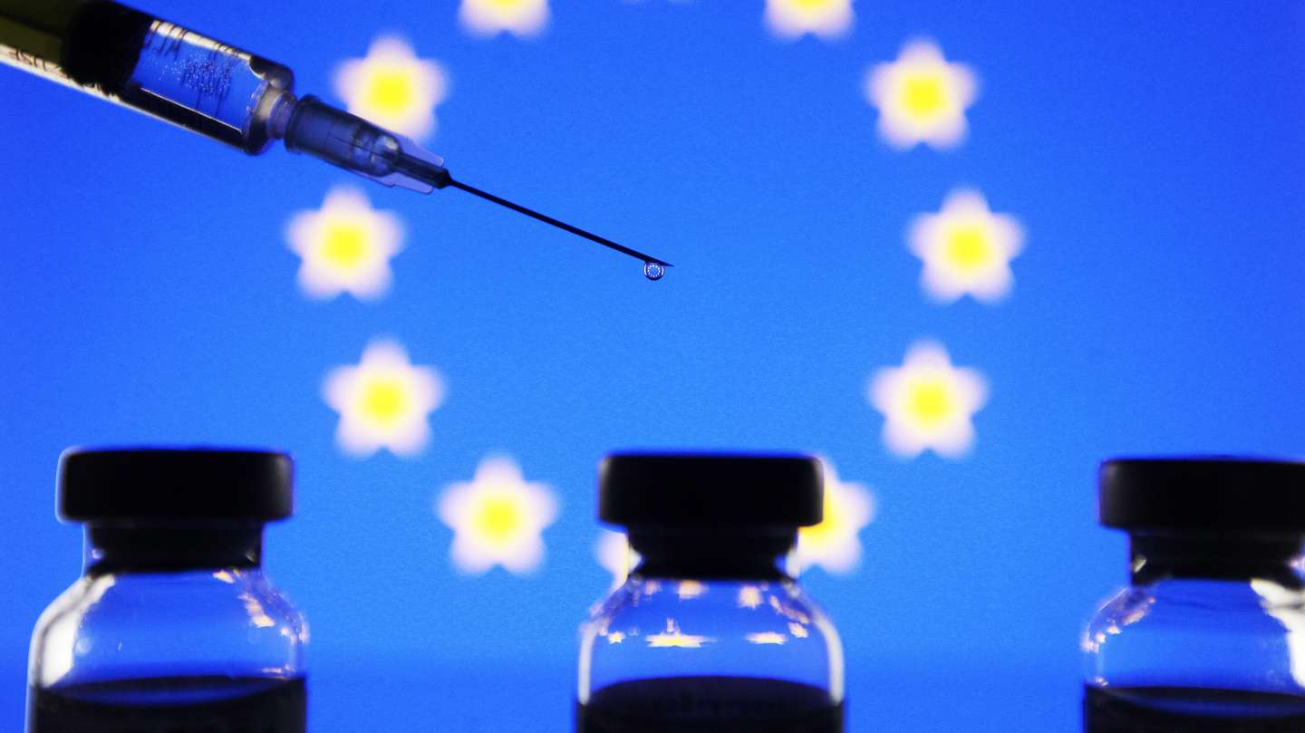 In this photo illustration the vials and a medical syringe