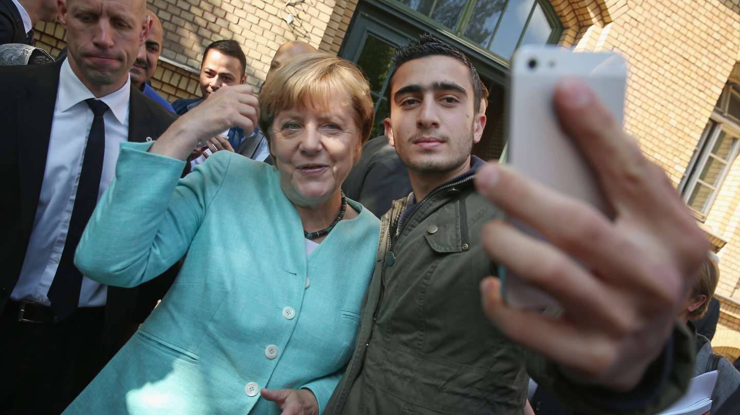 Merkel Visits Migrants' Shelter And School