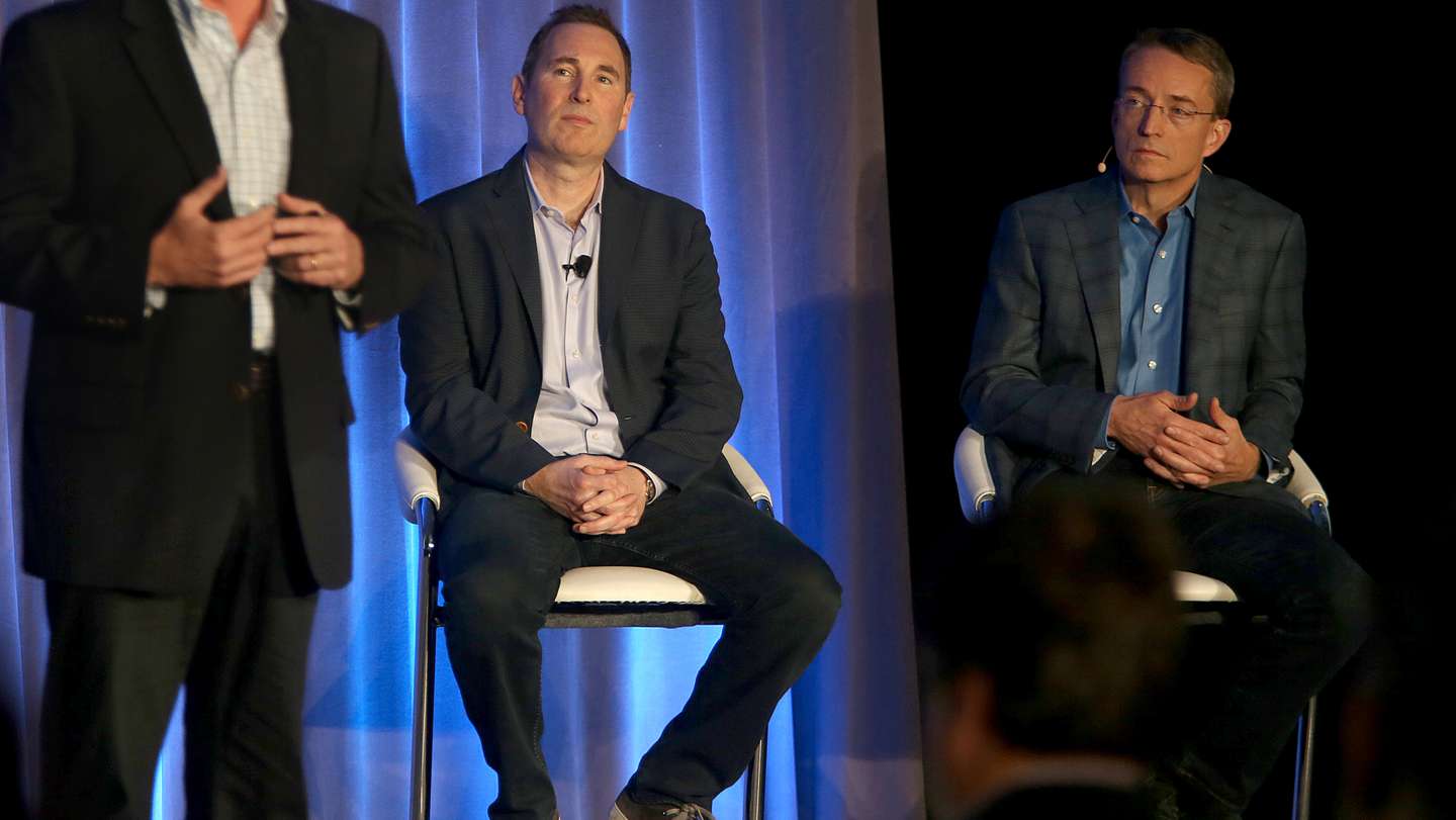 Western Digital CIO Steven Phillpott (left) speaks with CEO Andy Jassy (middle) and VMware CEO Parick P. Gelsinger (right) during a press conference announcing  Amazon's cloud service, AWS, partnering with VMware Cloud creating a new integrated cloud serv