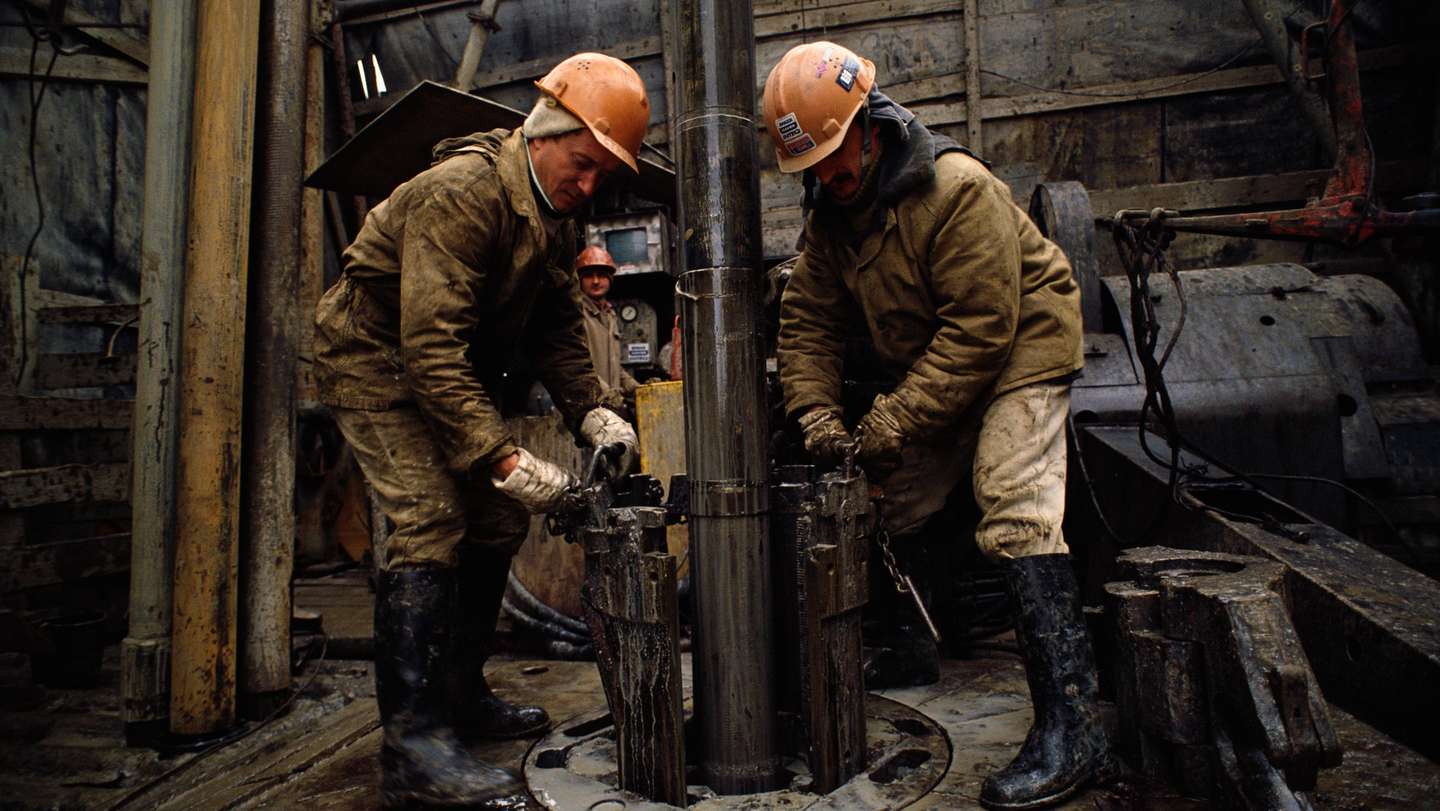 Workers Operate Oil Rig