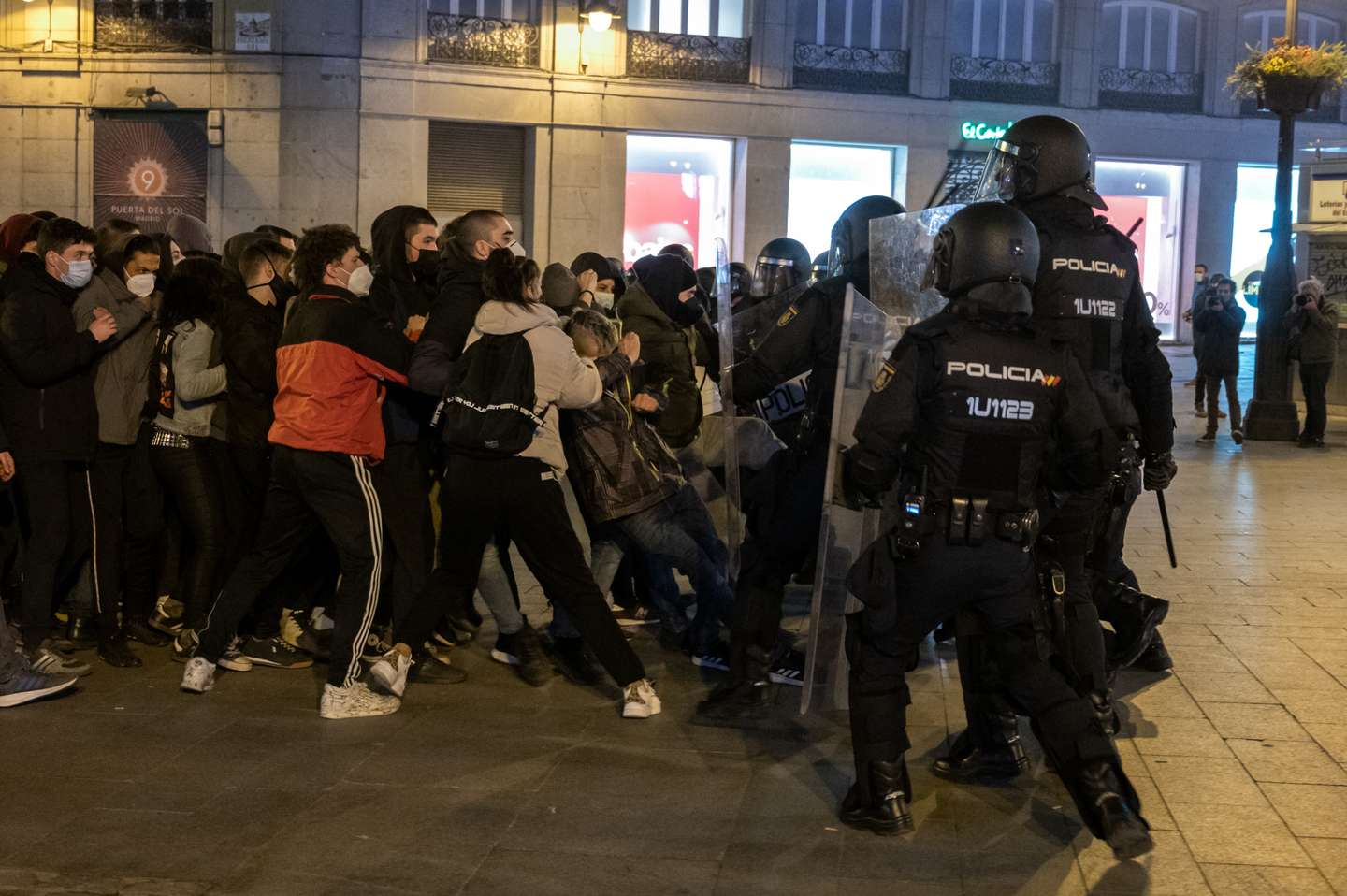 Riot police beating protesters during clashes in a
