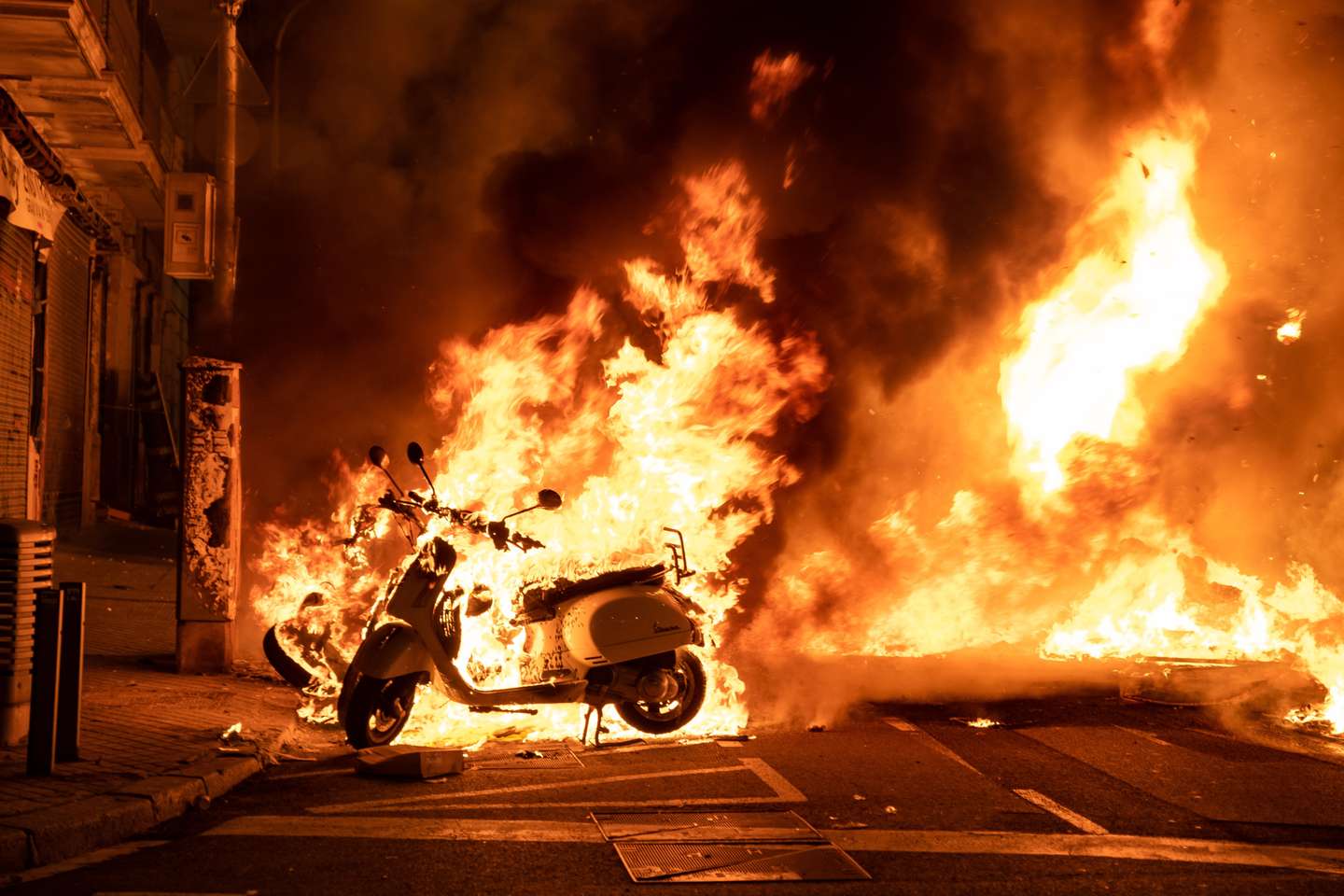 View of burning motorcycles on Balmes street on the corner