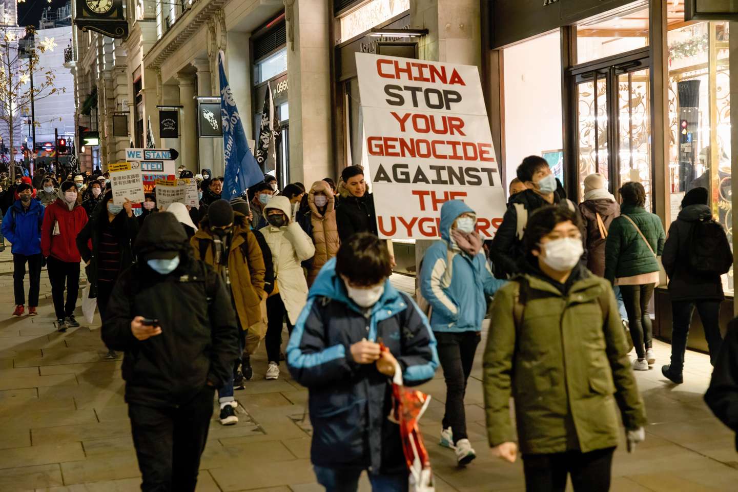 Protesters are seen holding a big placard that says "China