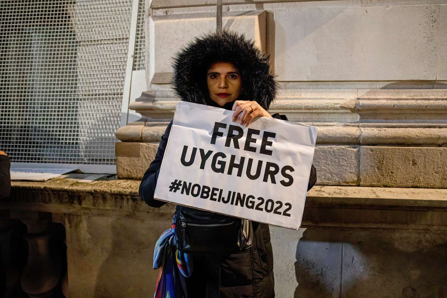 A woman protester is seen holding a placard that says "Free