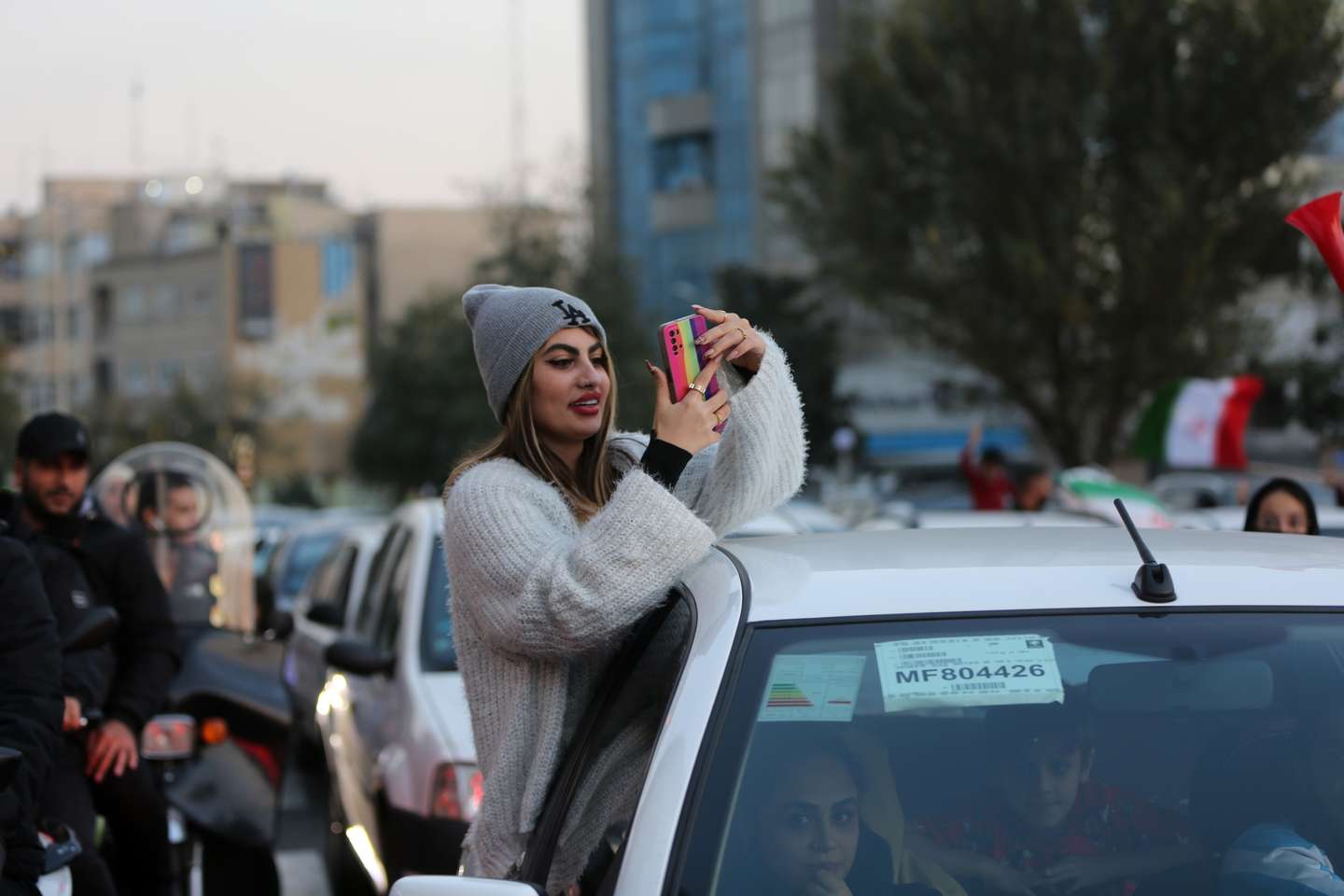People celebrate after Iran's win against Wales